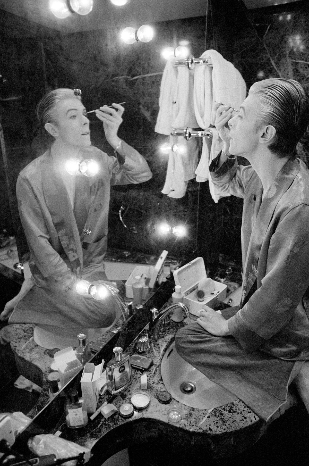 David Bowie prepares his make-up at L’Hotel in Paris ahead of photo shoot in 1976