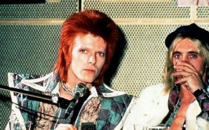 David Bowie and Mick Ronson during a press conference at RCA Studios in New York, 1972. By Bob Gruen