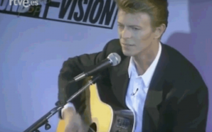 David Bowie plays acoustic guitar at the Sound & Vision tour press conference in 1990