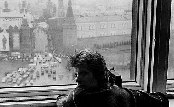 David Bowie photographed by Geoff MacCormack as he films the May Day parade in Moscow from his hotel room