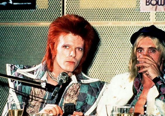 David Bowie and Mick Ronson during a press conference at RCA Studios in New York, 1972. By Bob Gruen